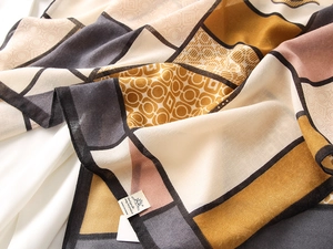 Close-up of geometric patchwork pattern and fine texture on soft cotton linen shawl
