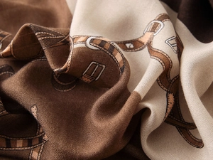 Macro shot of cotton-linen feel scarf showing vintage belt patterns and fabric texture