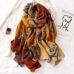Detail of elegant patterned shawl featuring classic belt prints and soft earth tones