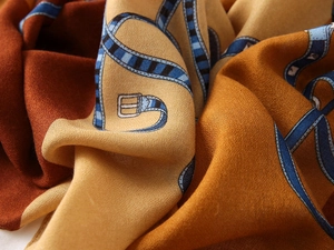 Close-up of cotton-linen feel scarf showing luxury drape and vintage belt patterns