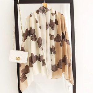 Detailed close-up of floral print cotton-linen shawl with chic beige color blocking