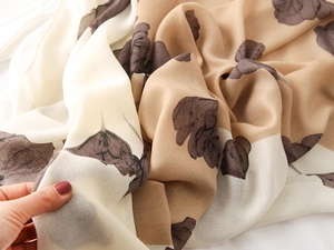 Close-up of lightweight cotton-linen feel scarf with khaki floral prints and soft texture