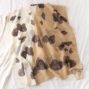 Detail of apricot tulip print scarf with delicate stitching and soft cotton-linen texture