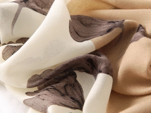 Detail of soft breathable cotton linen feel scarf with elegant coffee brown plant patterns