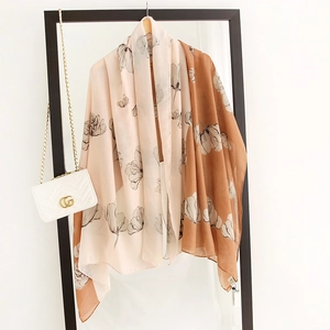 Detail of floral print shawl scarf with two-tone pink and caramel color splicing