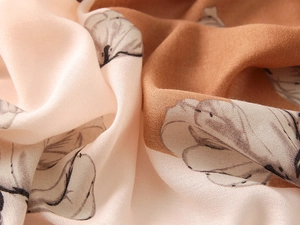 Close-up of soft floral cotton-linen scarf with elegant beige and brown artistic print