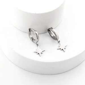 Silver octagonal star charm hoop earrings in polished steel on minimalist display