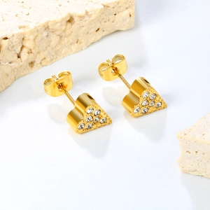 Detail of heart-shaped gold stainless steel earrings with sparkling white crystals