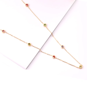 Minimalist gold necklace with multi-colored gemstones bezel-set on a delicate chain