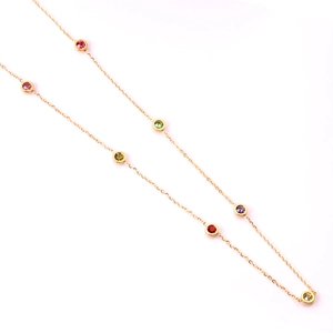 Detail of a gold O-chain necklace featuring colorful bezel-set rainbow gemstones