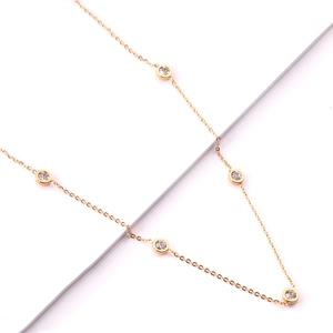 Minimalist French style gold chain necklace with five bezel-set sparkling round crystals