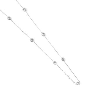 Detailed view of silver necklace with seven clear bezel-set cubic zirconia stones