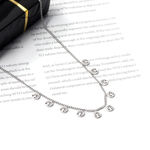 Detailed macro view of silver stainless steel chain with tree of life circle charms