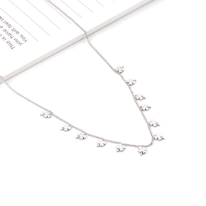 Detail view of silver stainless steel necklace featuring minimalist clover shaped charms