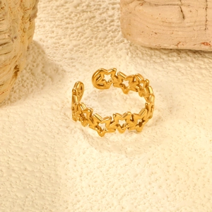 Close-up of golden hollow star adjustable ring on stone display stand