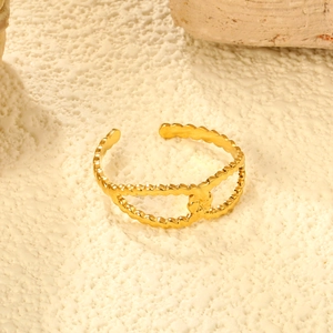 Detail of 18K gold-plated stainless steel ring with hollow structure and beaded texture