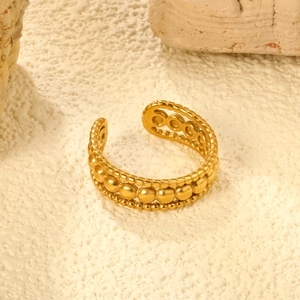 Macro view of adjustable 18K gold plated ring featuring layered metal bead textures