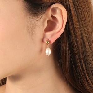Elegant freshwater pearl drop earrings with golden steel beads on female model