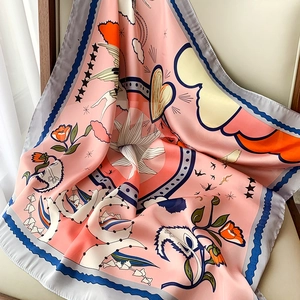 Detail of elegant pink silk square scarf with floral illustrations and scalloped blue edges