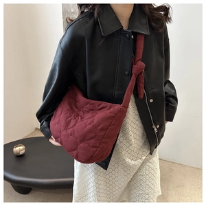 Large burgundy heart-quilted cloud bag with knotted strap for casual shoulder or crossbody wear