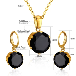 Macro shot of gold plated necklace and earrings set with black cubic zirconia details