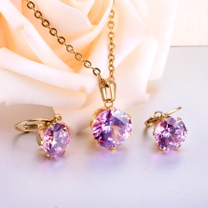 Macro detail of purple zircon pendant and earrings set with gold six-prong setting