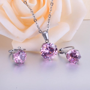 Elegant silver necklace and earrings set with pink six-prong zircons and roses