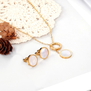Detailed set of gold necklace and earrings with white mother-of-pearl geometric pendants