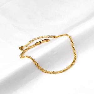 Detail of gold stainless steel flat snake chain with lobster clasp and heart charm