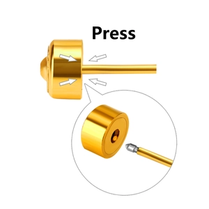 Macro detail of the press-to-lock mechanism and polished golden stud earring backing