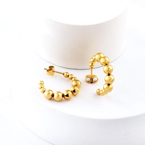Detail view of 18K gold plated stainless steel C-shape earrings with graduated beads