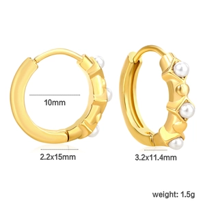 Detail view of gold huggie earrings with white zircon accents and size measurements