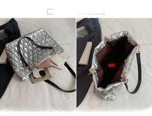 Detailed interior of a silver quilted tote bag showing large capacity and inner lining