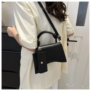 Détail du sac à main sablier avec bandoulière amovible et mini porte-monnaie assorti en breloque