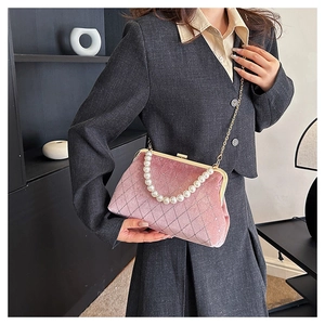 Pink velvet handbag with quilted diamond pattern and elegant pearl handle detail