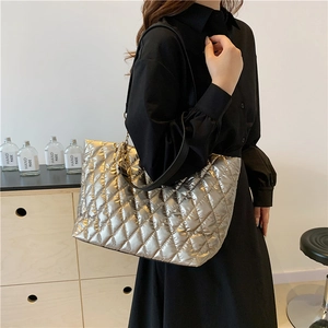 Large champagne gold quilted tote bag with lattice stitching and wide black strap