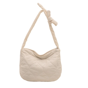 Cream quilted tote bag with heart stitching and knotted shoulder strap design