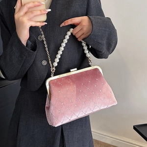 Pink velvet quilted handbag with pearl handle and rhinestone accents for evening wear
