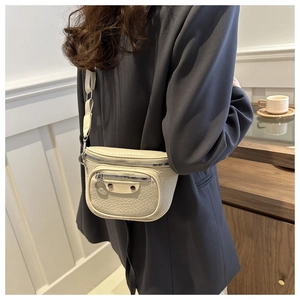 Close-up of cream lychee leather fanny pack featuring silver zippers and rivets details