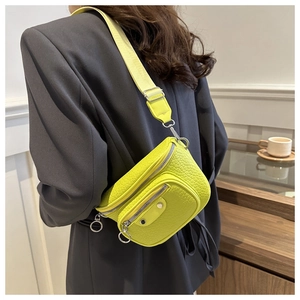 Rear view of model wearing a fluorescent green crocodile pattern leather crossbody waist bag