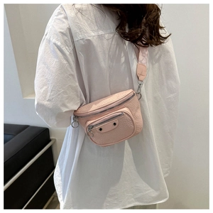 Detail of pink faux crocodile leather waist bag with double zippers and wide strap