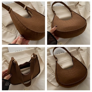 Detailed views of a dark brown crescent bag with crocodile pattern and golden zipper