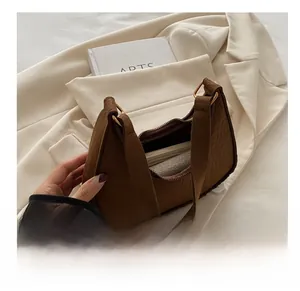 Detail view of brown crocodile-embossed felt hobo bag showing spacious inner compartment