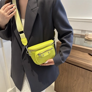 Neon yellow leather crossbody waist bag with silver studs and wide canvas strap