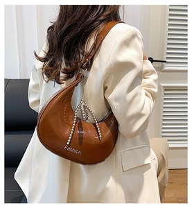 Brown leather crescent shoulder bag with metallic bead trim and Fashion print
