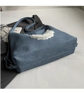 Detail showing blue denim tote bag with soft white plush patchwork and comfortable fabric texture