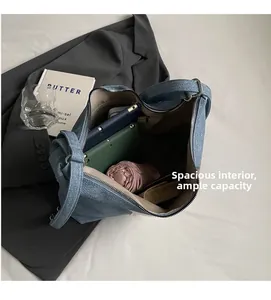 Spacious blue denim tote bag interior showing capacity for umbrella and daily essentials