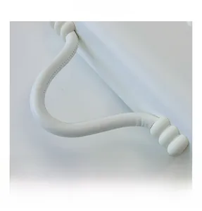 Close-up of wavy leather handle and golden metal hooks on white crossbody bag