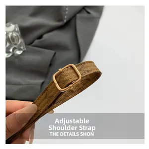 Detail of adjustable brown vintage monogram strap with a polished golden square buckle