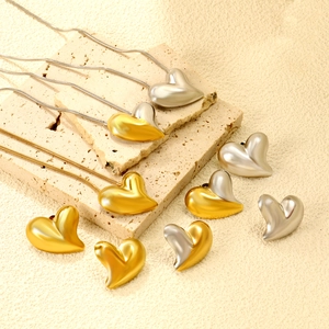 Contrast heart pendant necklace and earrings set in polished gold and silver stainless steel